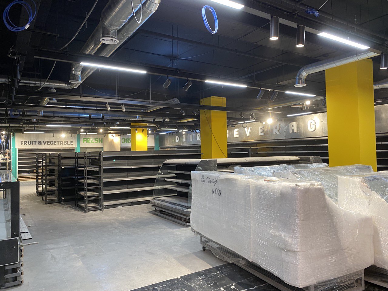 Premium supermarket fit-out with integrated refrigeration and aisle lighting